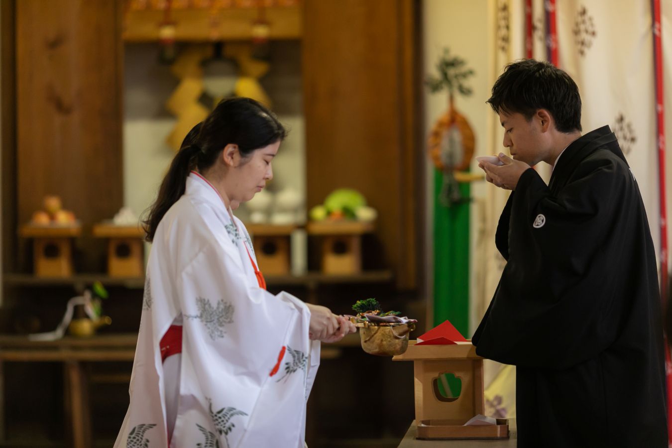 愛媛縣護國神社でご結婚式を挙げられたお客様の写真　三々九度をする紋付袴姿の新郎様